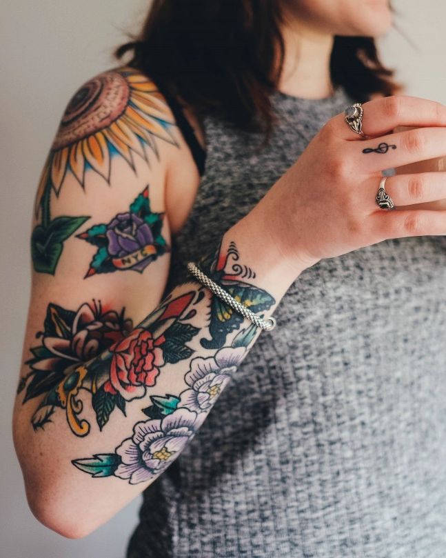 Colourful neo-traditional floral sleeve on a woman’s arm